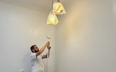 Painter rolling ceiling white paint, HDB Singapore service